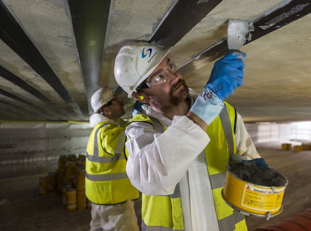 Structural strengthening with CFRP plates and FRP fabrics