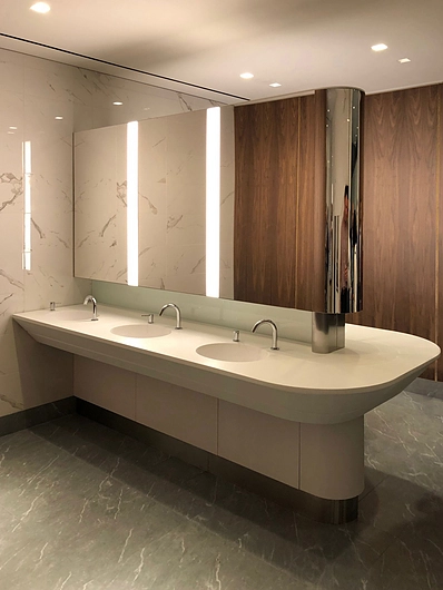Parklex water-resistant walnut wooden veneer panels applied to interior bathroom wall in 50 Hudson Yards building in New York