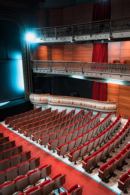 Custom red velvet chairs in Barcelona theatre