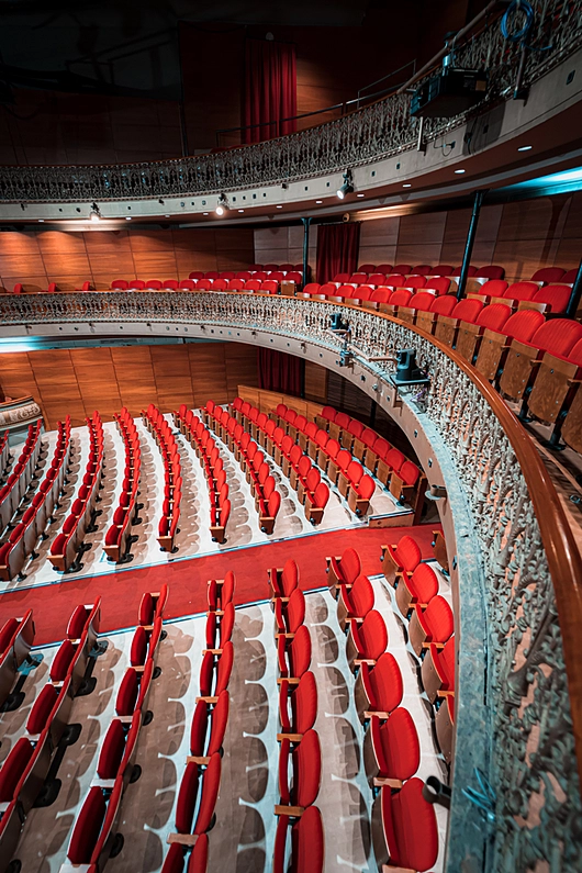 Custom red velvet chairs in Barcelona theatre