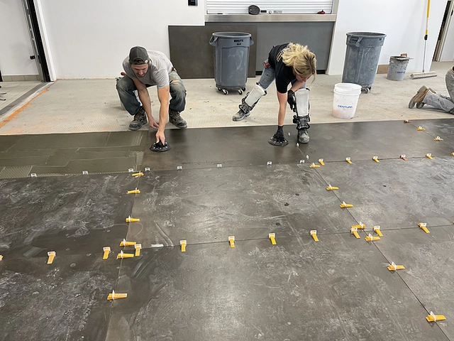 Proccess of DITRA membranes application on the floor levelling of the car showroom