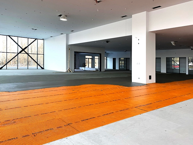 Proccess of DITRA membranes application on the floor levelling of the car showroom