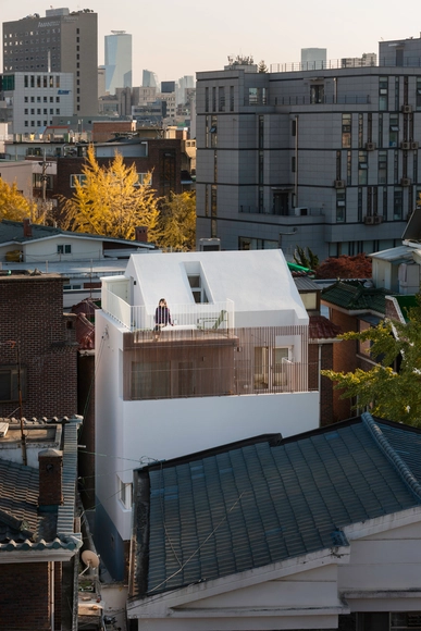 Seongsan-dong Uso mixto / a round architects - Casas